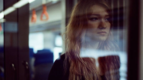 Portrait of a woman standing in a subway