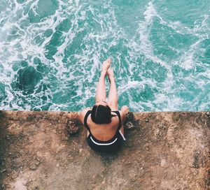 Young woman in sea against sky