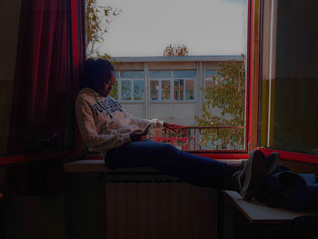 Woman looking at camera while sitting at home