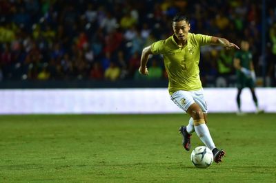 Man running with ball on grass