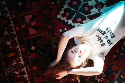 High angle portrait of woman lying on bed