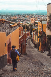 Rear view of people walking on street