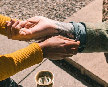 Cropped image of man holding coffee