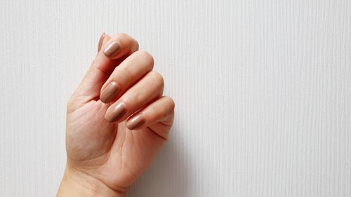 Close-up of woman hand on wall