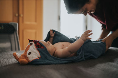 Mother dressing baby