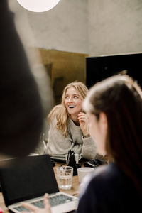 Smiling businesswoman looking away in office