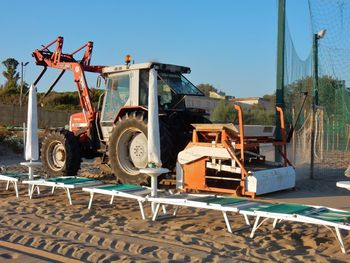 Tractor at construction site against clear sky