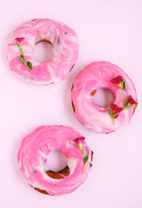 High angle view of pink roses against white background