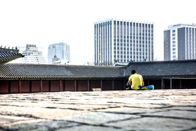 Rear view of woman standing in city