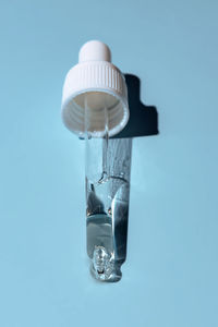 Close-up of bottle against blue background