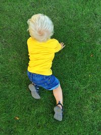 Rear view of girl playing on field