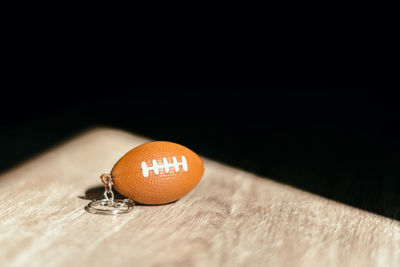 Close-up of orange on table against black background