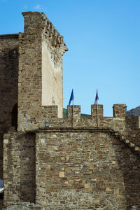 Low angle view of old building against blue sky
