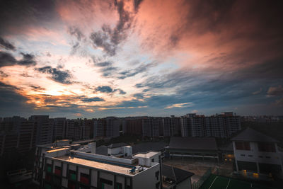 High angle view of buildings against dramatic sky