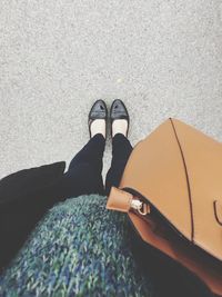 Low section of woman standing on tiled floor