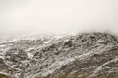 Scenic view of mountains against sky during winter