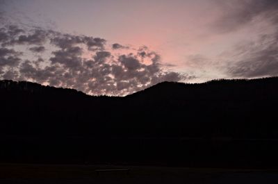 Scenic view of silhouette mountains against sky at sunset