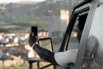 African american black skinned man with mobile phone and curly hair