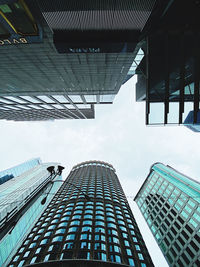 Low angle view of modern glass building against sky