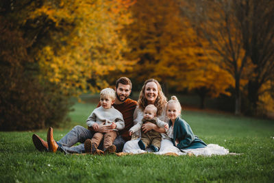 High angle view of father and son on tree during autumn