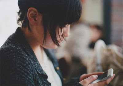 Close-up of woman using mobile phone