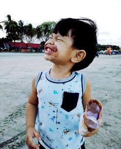 Cute boy standing on beach