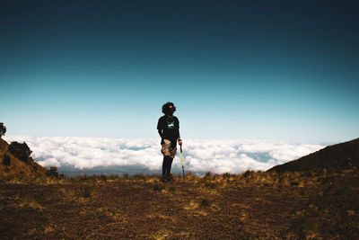 Full length of man standing on field against sky