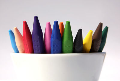 Close-up of colored pencils against white background