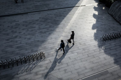 High angle view of people walking on footpath