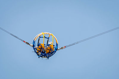 Low angle view of decoration hanging against clear blue sky