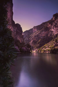 Scenic view of river and mountains against clear sky