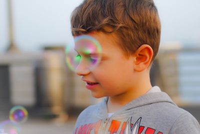 Close-up portrait of boy with bubbles