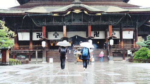 Group of people walking in front of building