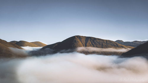 Panoramic view of mountain range against clear sky