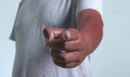 Close-up of man hand over black background