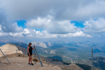 Man standing on mountain against sky