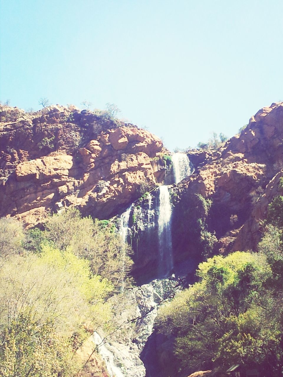 clear sky, copy space, rock - object, mountain, rock formation, scenics, nature, beauty in nature, built structure, tranquility, tranquil scene, architecture, water, tree, landscape, non-urban scene, day, rocky mountains, outdoors, rock