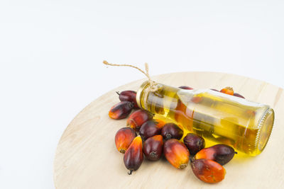 High angle view of fruits on table against white background