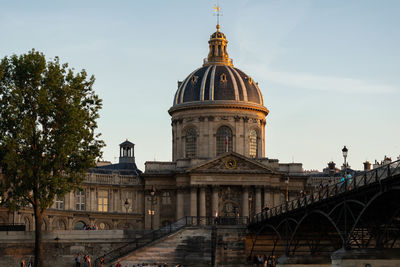 View of institute of france against sky in city. from the pont des arts. paris-france, 31. may 2019.