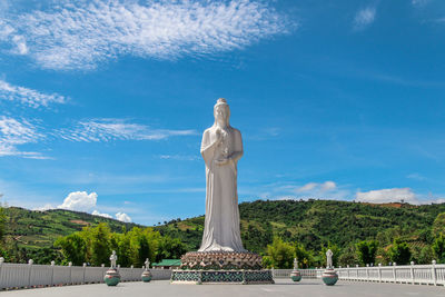 Statue of buddha against blue sky