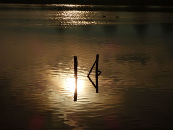 Scenic view of lake at sunset