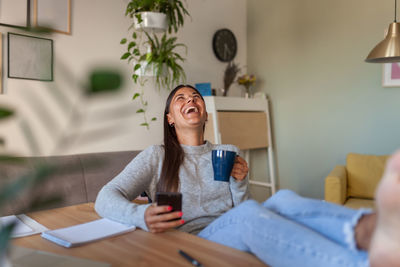 Young woman sitting at home