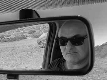 Portrait of man wearing sunglasses in car