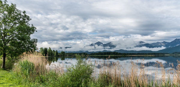 Scenic view of lake and mountains against sky