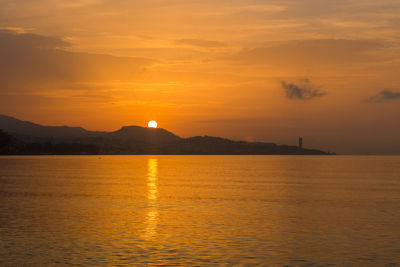 Scenic view of sea against orange sky