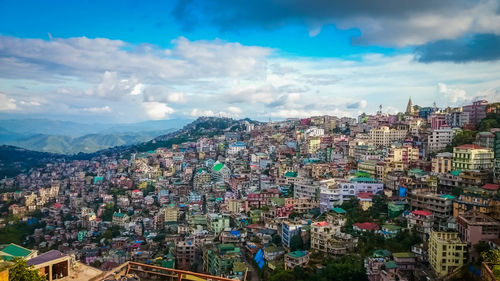 High angle view of city against cloudy sky