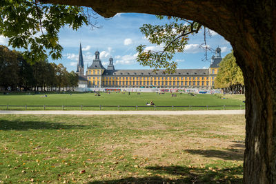Group of people on field against buildings