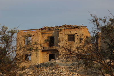 Abandoned building against clear sky