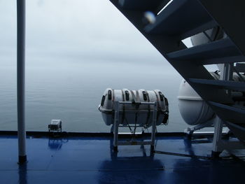 Scenic view of life raft on ship against sky