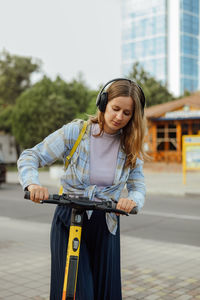 Portrait of young woman standing on street